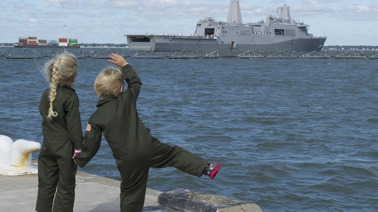 Navy Brats waving at ship